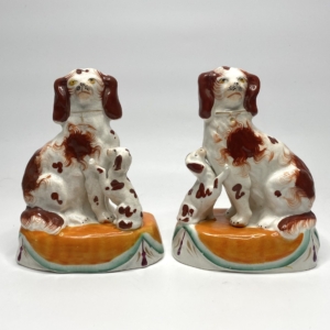 Pair Staffordshire pottery Spaniels with puppies, c. 1850.